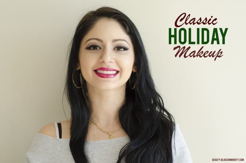 A woman with dark hair with classic holiday makeup