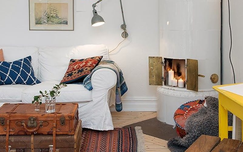 A living room with a couch, table, and candles