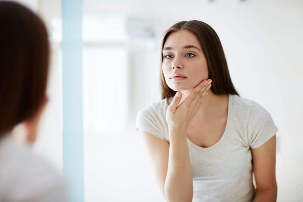 A woman looking at herself in a mirror